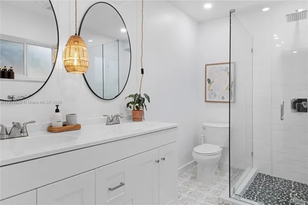 a bathroom with a sink a toilet and a mirror