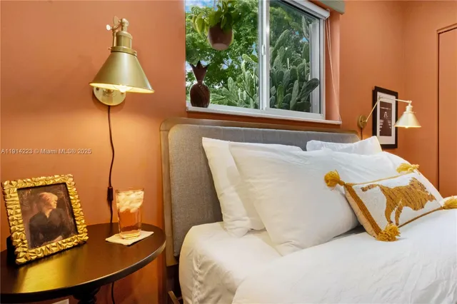 a bed sitting in a bedroom next to a window