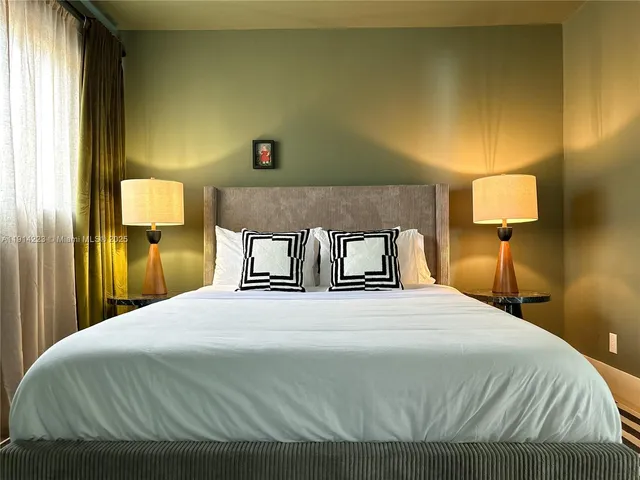 a bedroom with a bed and a night stand