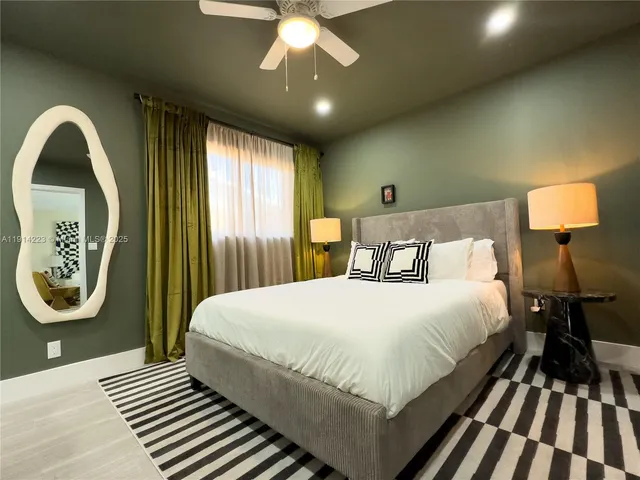 a bedroom with a large bed and a window