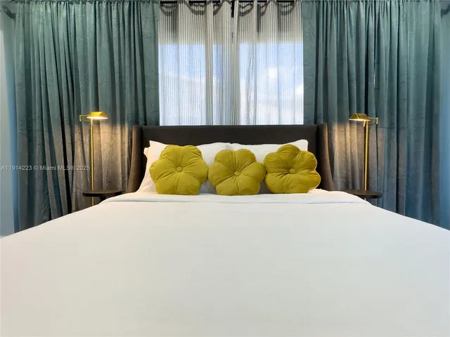 a bed sitting in a bedroom next to a window