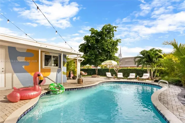 a backyard of a house with yard table and chairs