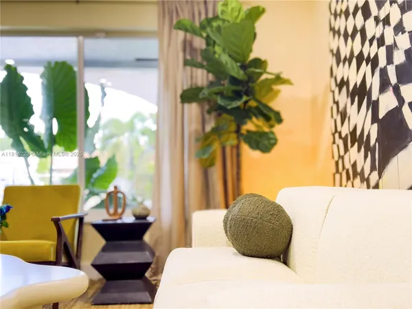 a bedroom with a bed potted plant and a large window