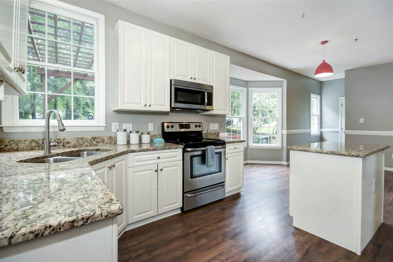 5300 Halcott Court Raleigh, NC 27613 - Photo 8 of 23 Updated kitchen features granite counter tops with coveted white cabinets, lots of storage, an island, stainless steel appliances and pantry. Kitchen