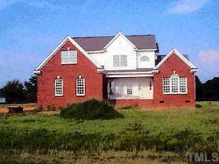 40 Meadow Ridge Dunn, NC 28334 - Photo 1 of 1 a front view of a house with a garden