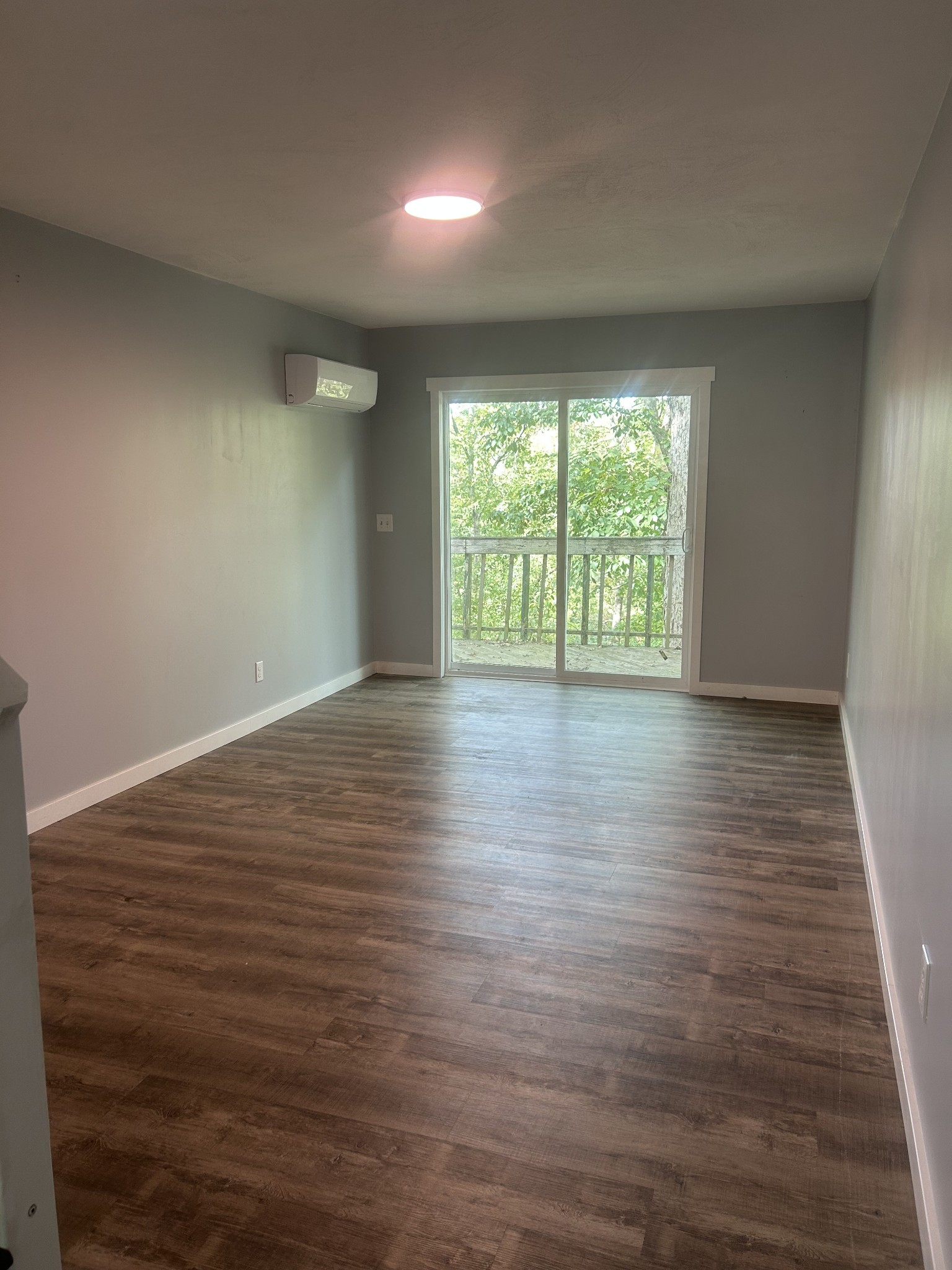 370 Alpine Road Camden, TN 38320 - Photo 18 of 20 a view of an empty room with wooden floor and a window