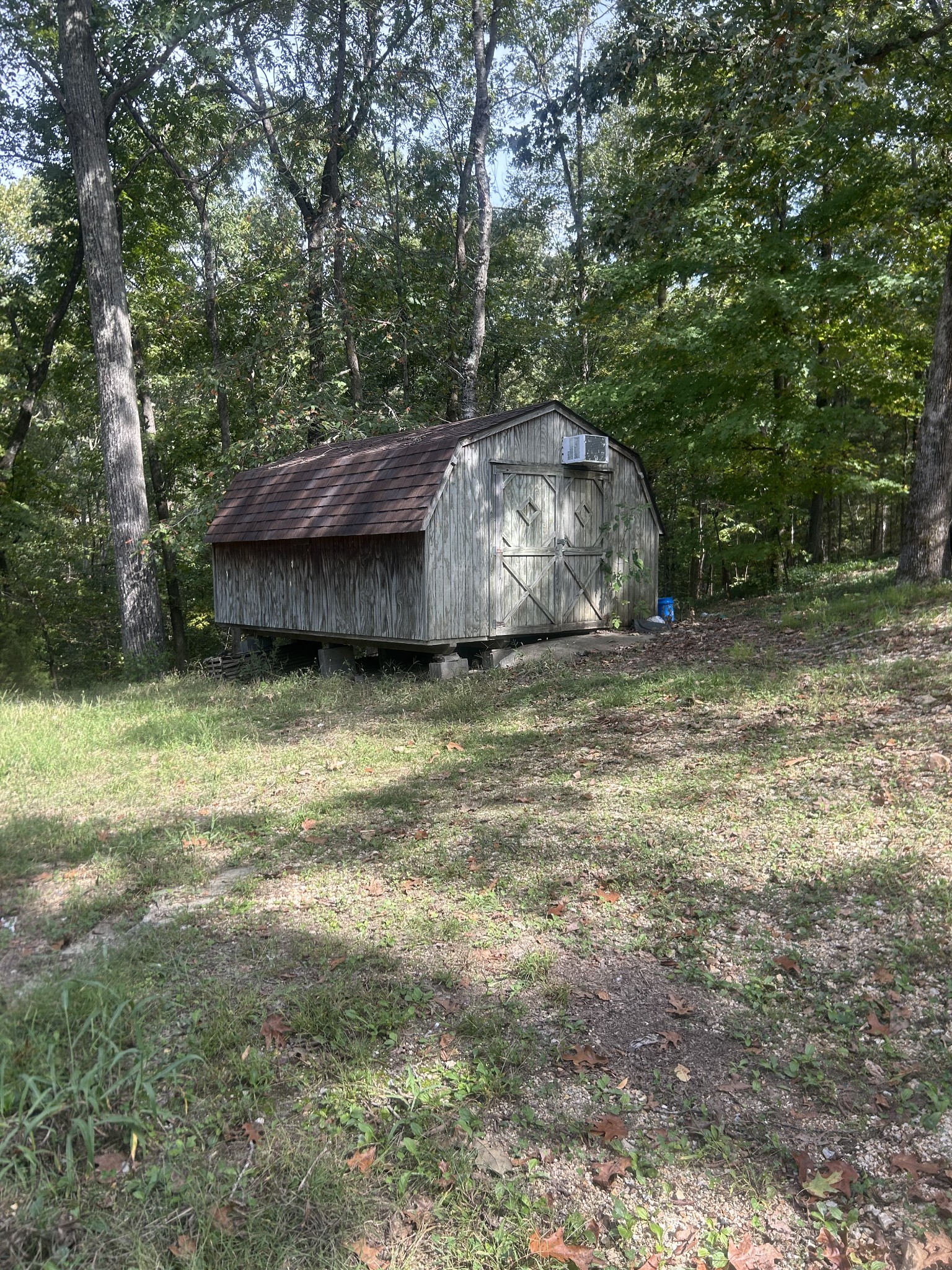 370 Alpine Road Camden, TN 38320 - Photo 20 of 20 a view of a wooden house with a yard and large trees