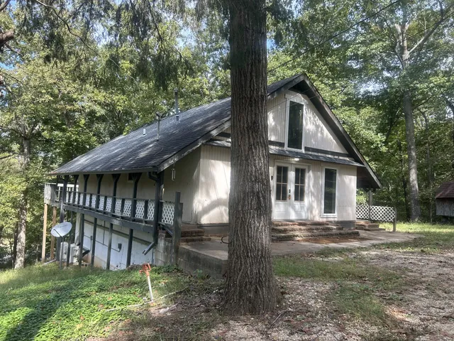 a view of a house with a yard and wooden fence