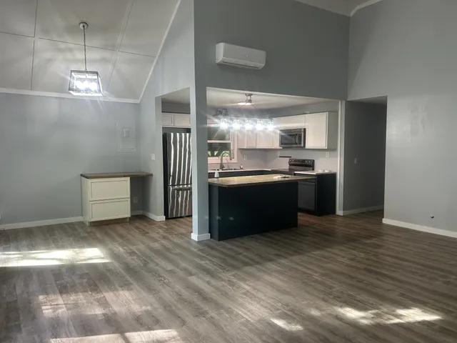 a kitchen with stainless steel appliances granite countertop a sink and a stove