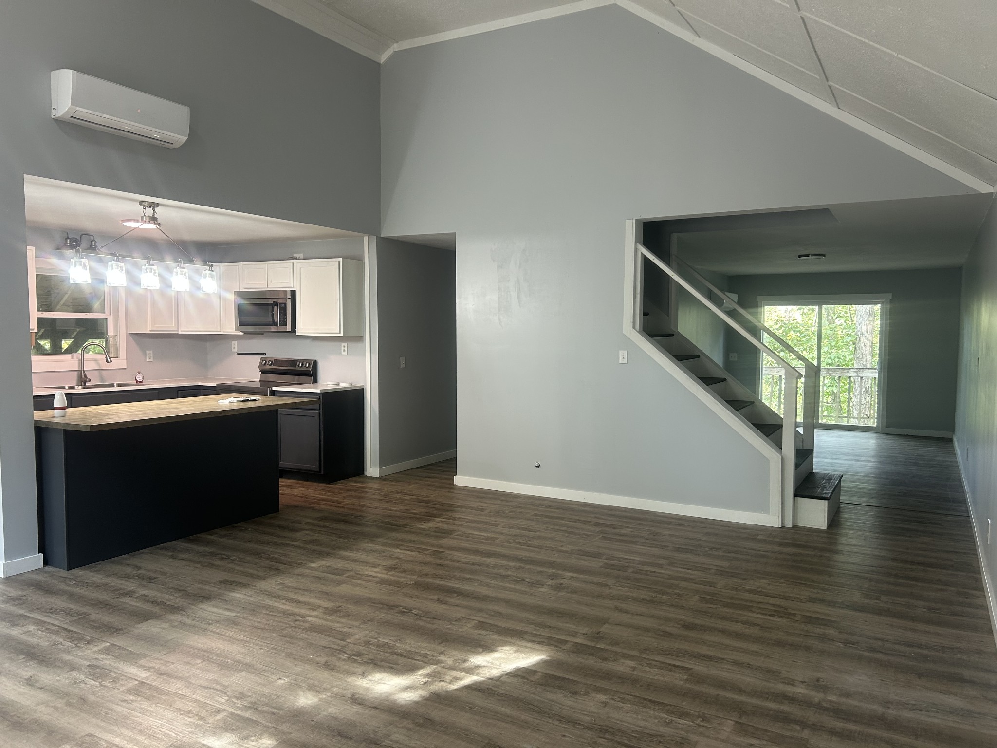 370 Alpine Road Camden, TN 38320 - Photo 4 of 20 a kitchen with stainless steel appliances granite countertop a refrigerator a sink dishwasher a stove and white countertops with wooden floor