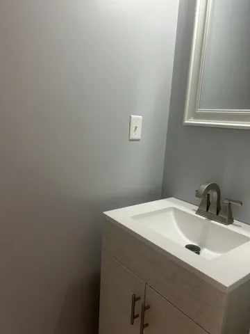 a bathroom with a sink and vanity