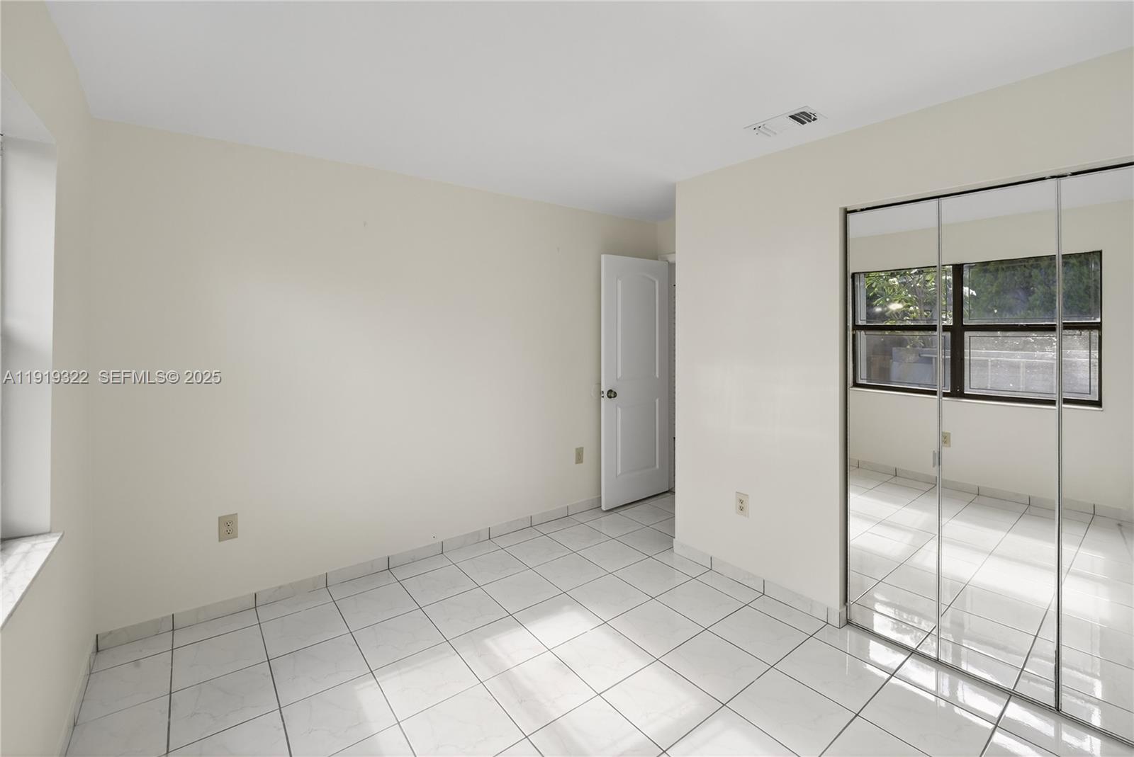 13675 Southwest 62nd Street, Unit 1023 Miami, FL 33183 - Photo 13 of 29 a view of an empty room and window