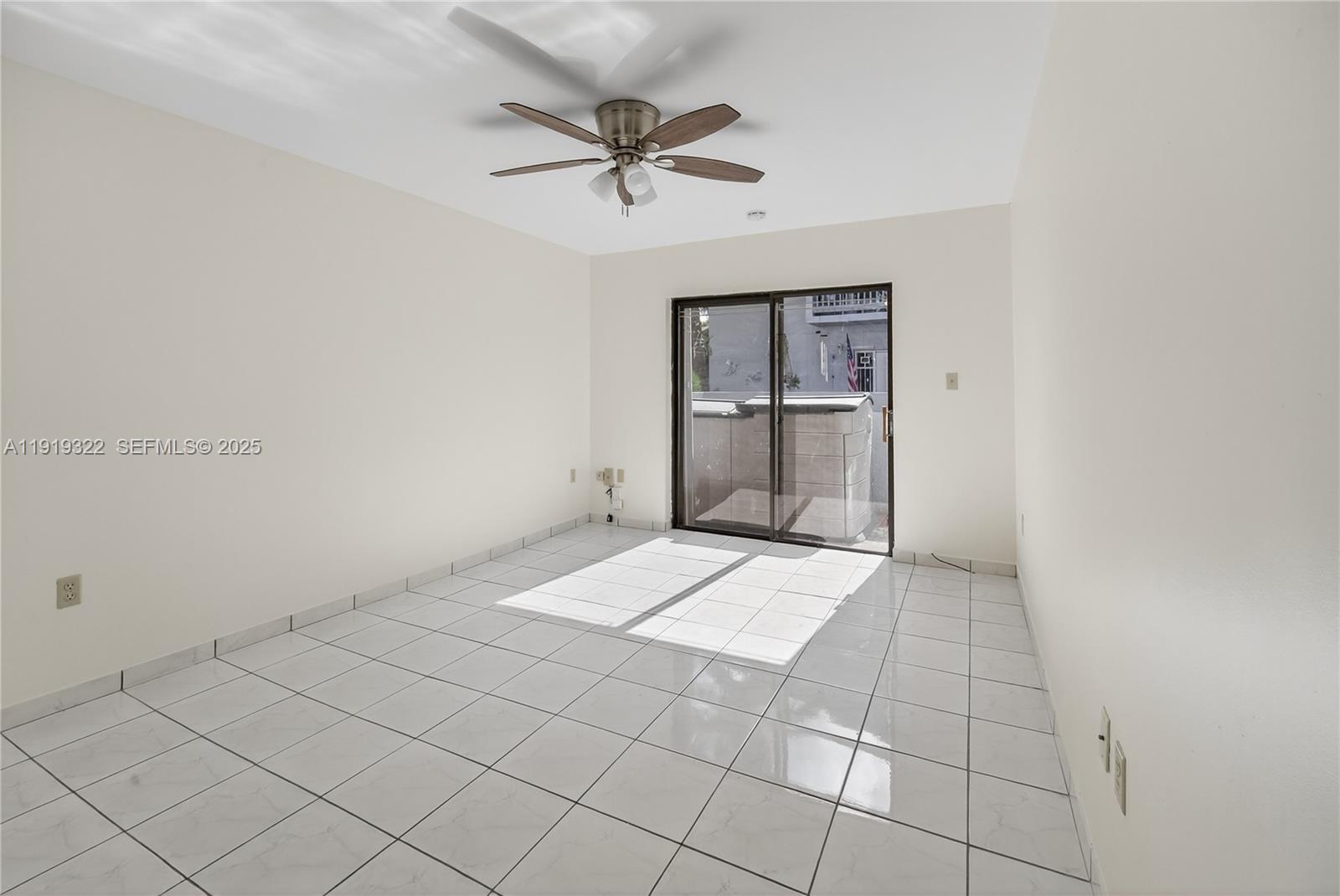 13675 Southwest 62nd Street, Unit 1023 Miami, FL 33183 - Photo 17 of 29 a view of a livingroom with a ceiling fan and window