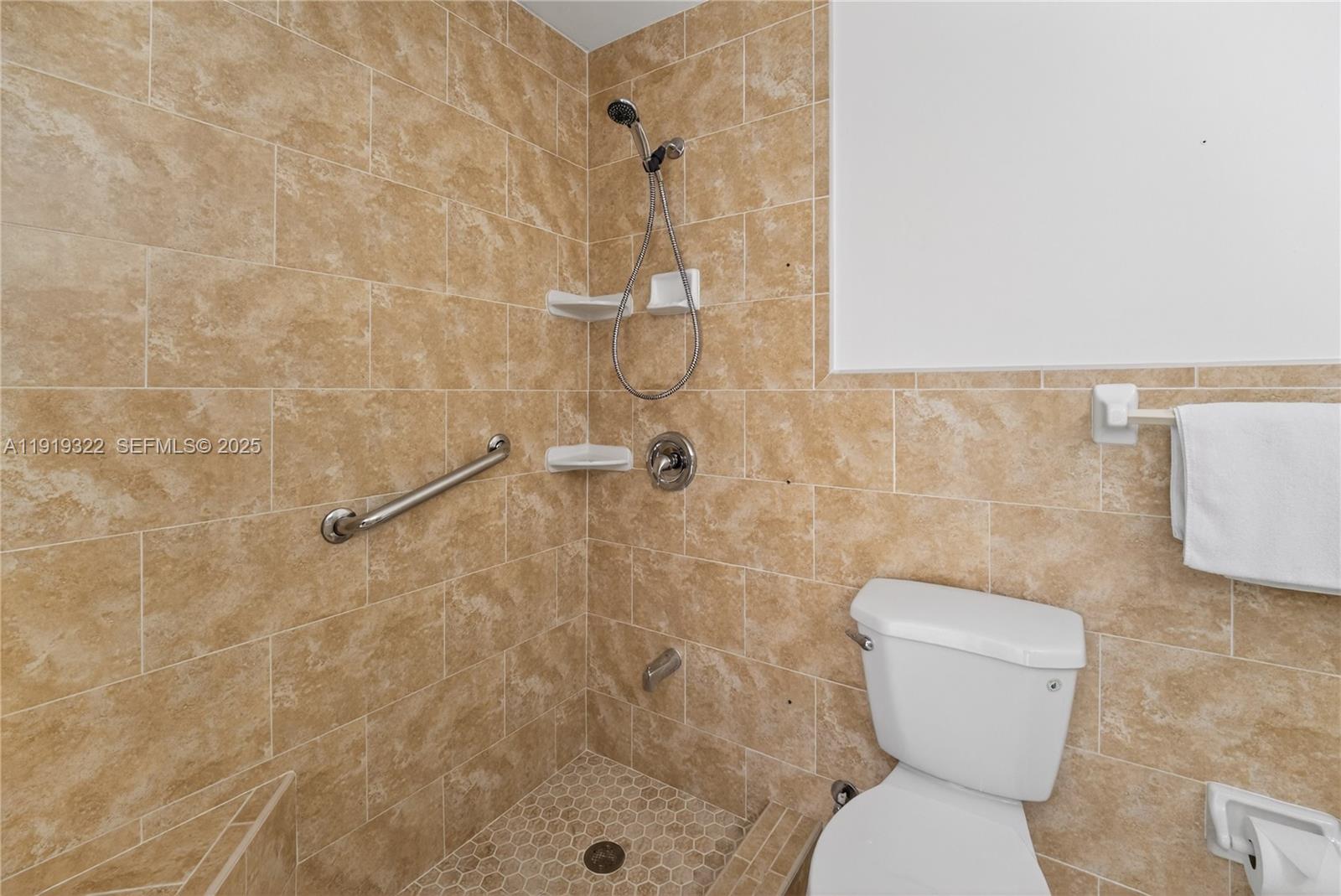 13675 Southwest 62nd Street, Unit 1023 Miami, FL 33183 - Photo 23 of 29 a bathroom with a toilet and a shower