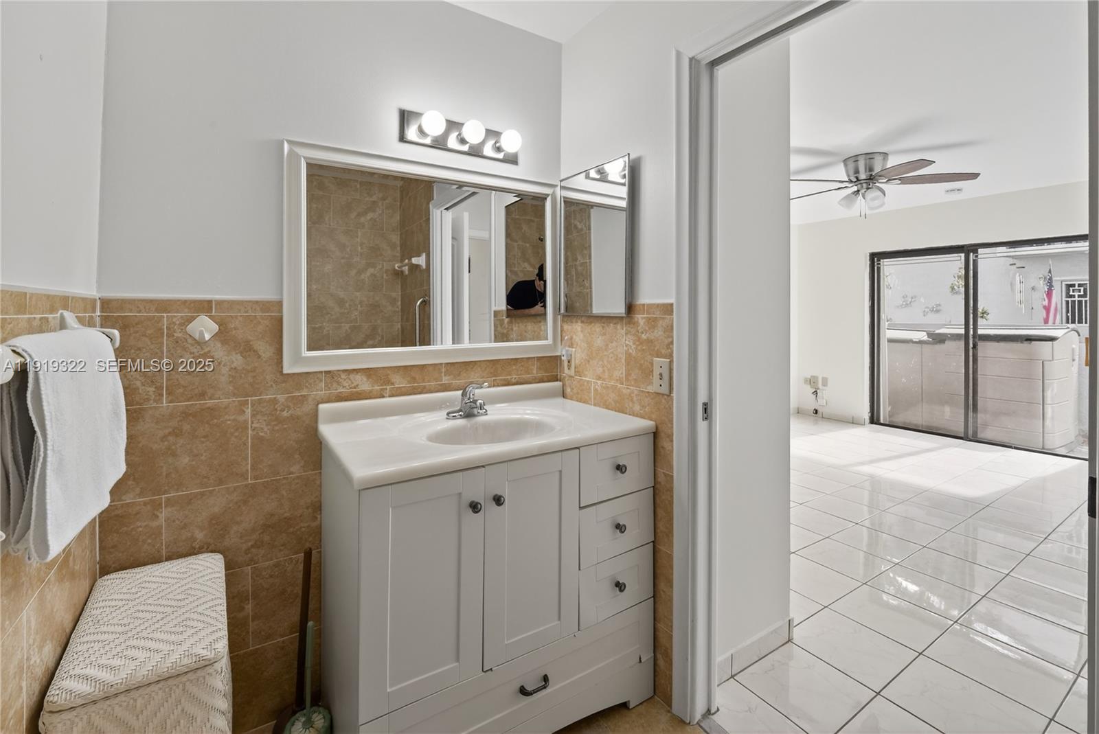13675 Southwest 62nd Street, Unit 1023 Miami, FL 33183 - Photo 24 of 29 a bathroom with a granite countertop sink a mirror and shower
