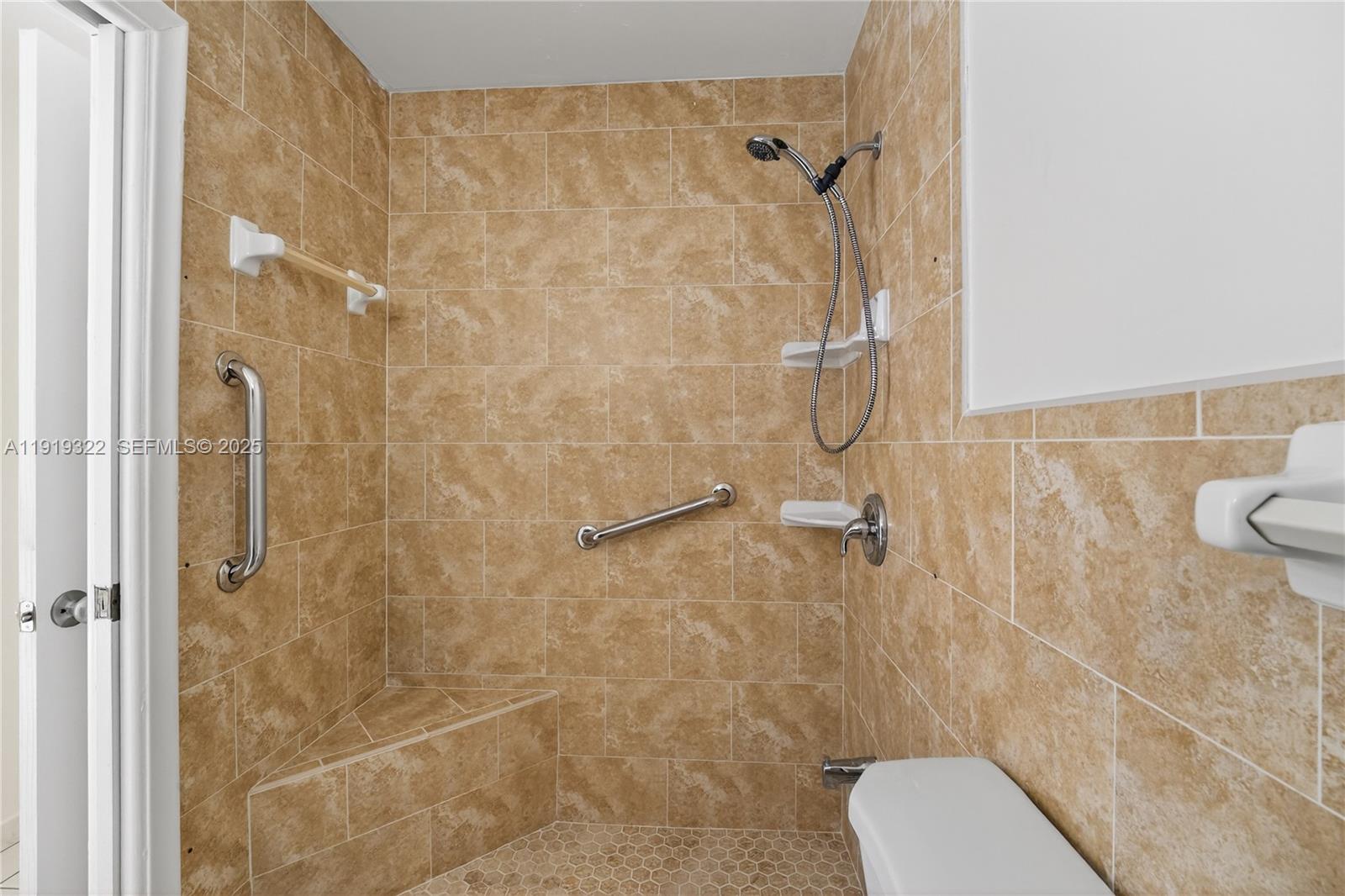 13675 Southwest 62nd Street, Unit 1023 Miami, FL 33183 - Photo 25 of 29 a bathroom with a shower and toilet