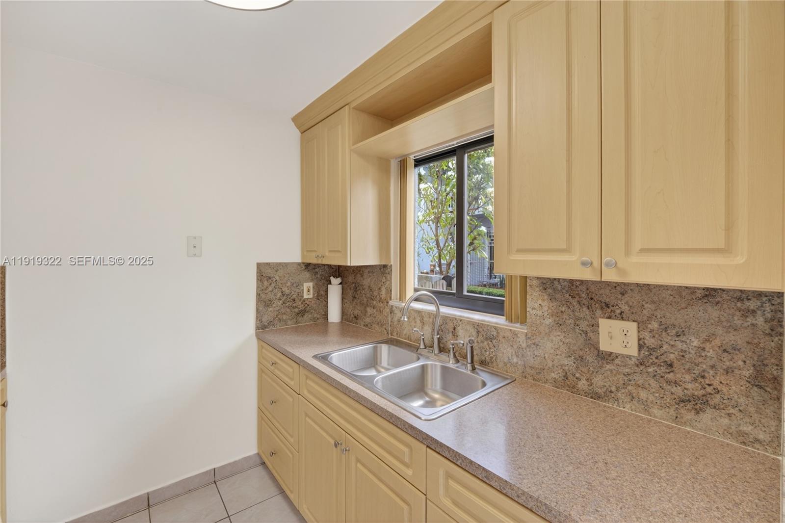 13675 Southwest 62nd Street, Unit 1023 Miami, FL 33183 - Photo 7 of 29 a bathroom with a sink a bathtub and next to a window