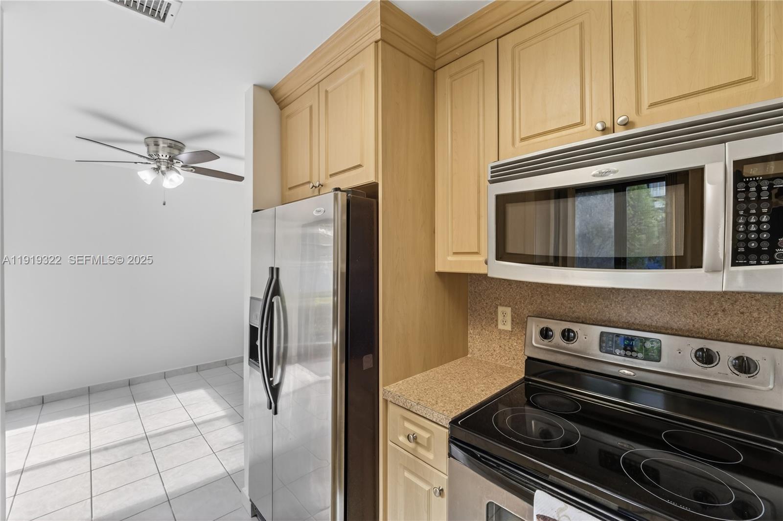 13675 Southwest 62nd Street, Unit 1023 Miami, FL 33183 - Photo 9 of 29 a stove top oven sitting inside of a kitchen