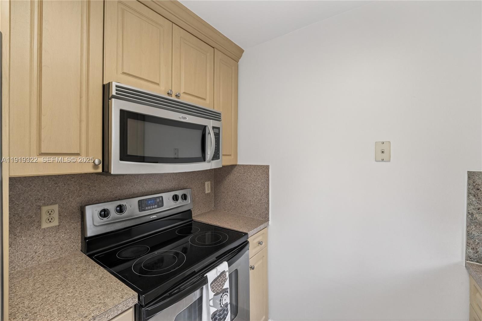 13675 Southwest 62nd Street, Unit 1023 Miami, FL 33183 - Photo 10 of 29 a kitchen with a stove and a microwave