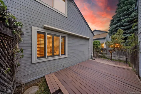 a view of a house with backyard and wooden fence