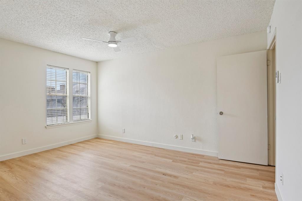 5300 Keller Springs Road, Unit 2055 Dallas, TX 75248 - Photo 8 of 24 Light wood-finish flooring complements the neutral wall tones