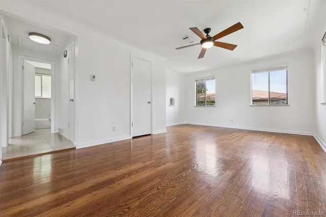 a view of empty room with wooden floor