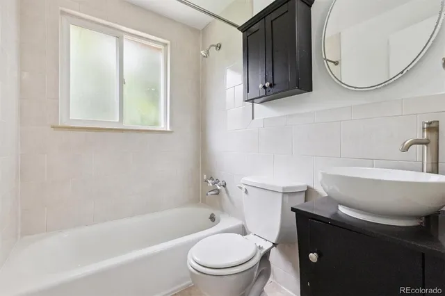 a bathroom with a sink a toilet and a bathtub