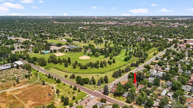 an aerial view of residential houses with outdoor space and trees