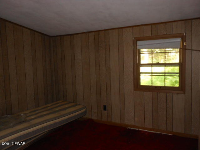207 Aspen Road Dingmans Ferry, PA 18328 - Photo 15 of 22 a wooden door in a bedroom