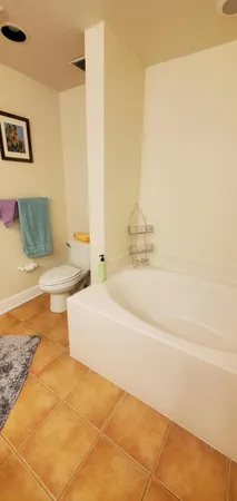 a bed sitting in a bedroom next to a window with tv