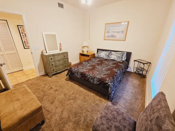 a bedroom with a bed and a table in it