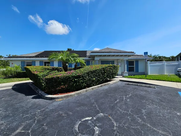 a backyard of a house with table and chairs