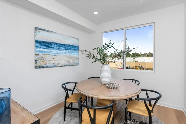 a view of a dining room with furniture and a potted plant