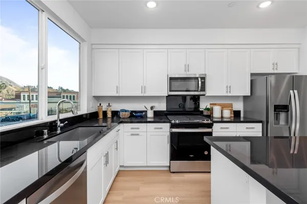 a kitchen with a sink stove and refrigerator