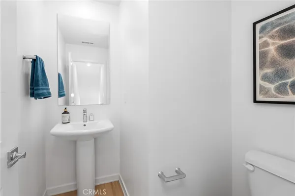 a bathroom with a sink toilet and mirror