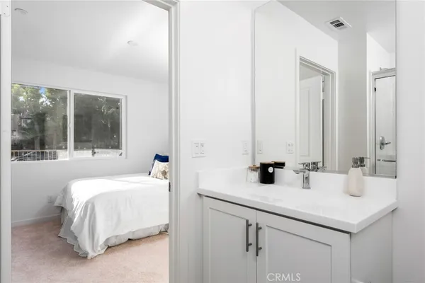 a bathroom with 2 sink and a mirror