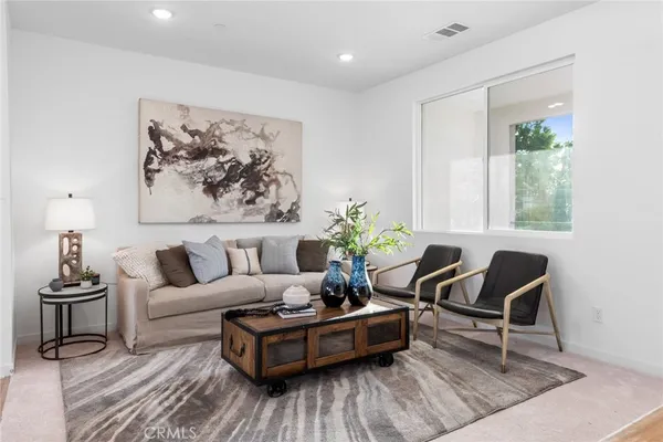a living room with furniture and a potted plant