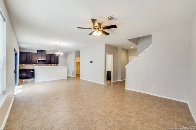 a view of a kitchen with a sink and a chandelier fan