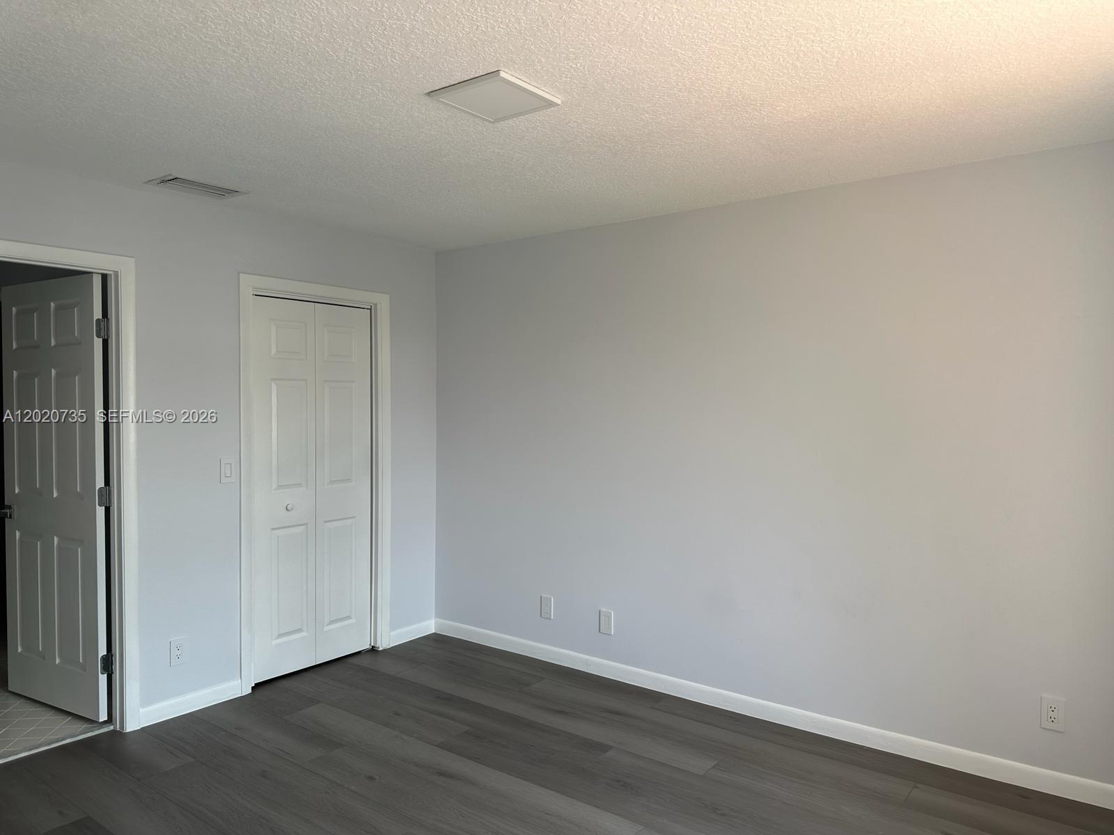 17244 Balboa Point Way Boca Raton, FL 33487 - Photo 21 of 66 a view of an empty room with wooden floor and closet
