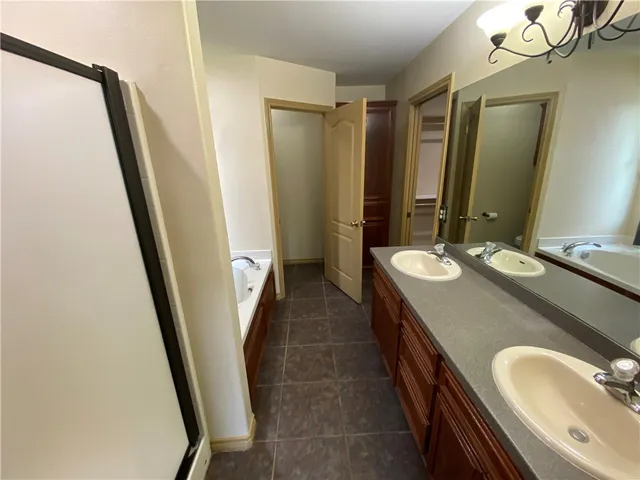 a bathroom with double vanity sink and mirror
