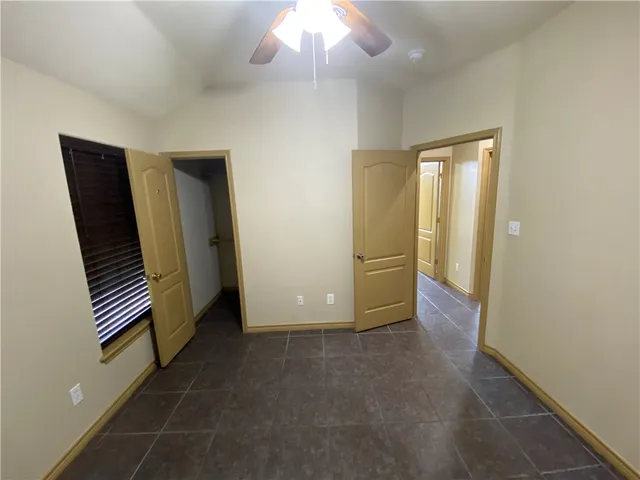 an empty room with staircase and a workspace