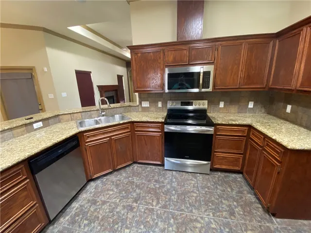 a kitchen with a sink stove and microwave