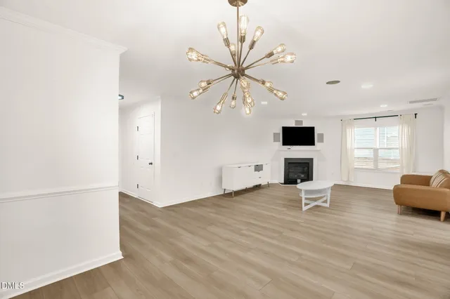 a kitchen with stainless steel appliances granite countertop a stove top oven a sink dishwasher and a microwave oven with white cabinets