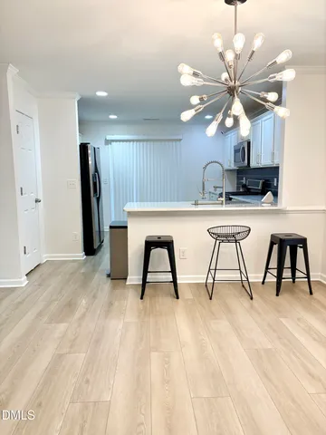 a view of a kitchen with a sink and a refrigerator
