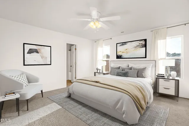 an empty room with windows and ceiling fan