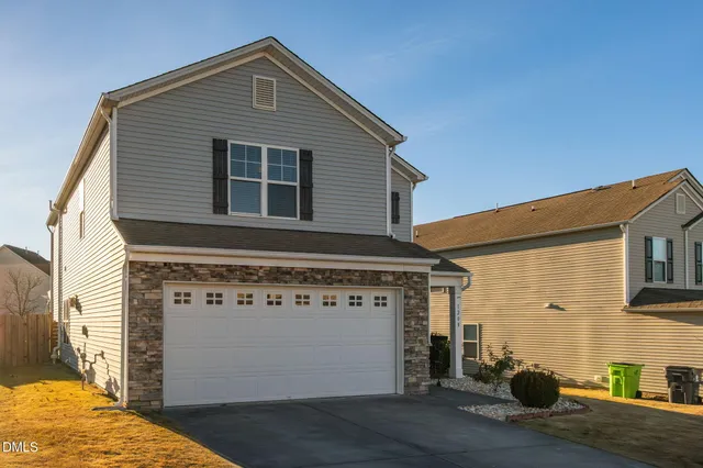 a front view of a house with a garage
