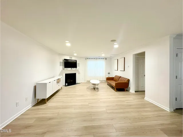a large white room with a bed and furniture
