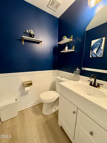 a bathroom with a sink a toilet and mirror