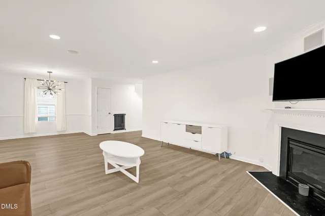 a living room with a fireplace and a flat screen tv