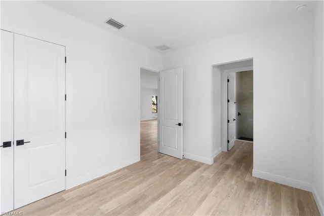 a view of a room with wooden floor